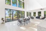 Soaring ceilings, walls of windows, clean, crisp finishes, and stunning lake views